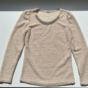 Cream coloured sweater with gem decorated collar